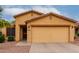 Charming front exterior view with a two-car garage and easy-care desert landscaping at 16261 W Custer Ln, Surprise, AZ 85379