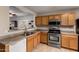 Bright kitchen features stainless steel appliances, tile floors, and light wood cabinetry at 16261 W Custer Ln, Surprise, AZ 85379