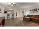 Inviting living room with brown sectional sofa open to the kitchen bar seating at 16261 W Custer Ln, Surprise, AZ 85379