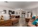 Spacious living room with a large brown sectional sofa and tiled floors at 16261 W Custer Ln, Surprise, AZ 85379
