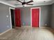 Spacious bedroom with hardwood floors and two red doors at 1629 E Garfield St, Phoenix, AZ 85006