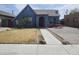 Charming blue home with drought-tolerant landscaping and red front door creates curb appeal at 1629 E Garfield St, Phoenix, AZ 85006