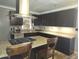 Open kitchen with dark cabinets, granite counters, and stainless steel range at 1629 E Garfield St, Phoenix, AZ 85006