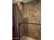Stylish shower featuring tile walls, bronze fixtures, and a rainfall shower head at 1629 E Garfield St, Phoenix, AZ 85006