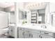 Tastefully renovated bathroom with dual sinks, tile countertops, and a glass-enclosed shower at 1633 E Lakeside Dr # 48, Gilbert, AZ 85234