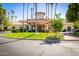 Elegant clubhouse exterior featuring a circular driveway, lush landscaping, and well-manicured lawns at 1633 E Lakeside Dr # 48, Gilbert, AZ 85234