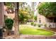 Community green space with mature landscaping and green grass at 1633 E Lakeside Dr # 48, Gilbert, AZ 85234