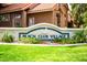 Inviting Beach Club Village sign surrounded by lush landscaping and well manicured lawn at 1633 E Lakeside Dr # 48, Gilbert, AZ 85234