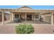 Covered patio area with outdoor seating and a built-in grill at 16427 W Labyrinth Ln, Surprise, AZ 85374
