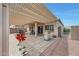 Backyard with dining and BBQ area under a covered patio at 16427 W Labyrinth Ln, Surprise, AZ 85374