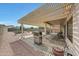 Relaxing backyard patio with a grill under a covered pergola, perfect for outdoor dining at 16427 W Labyrinth Ln, Surprise, AZ 85374
