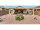 Wide backyard with a covered patio featuring outdoor seating and a grill at 16427 W Labyrinth Ln, Surprise, AZ 85374