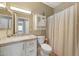 Cozy bathroom with a vanity featuring a granite countertop and a shower with a curtain at 16427 W Labyrinth Ln, Surprise, AZ 85374