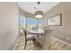 Charming breakfast nook with a round table, cushioned chairs, and a sunlit bay window at 16427 W Labyrinth Ln, Surprise, AZ 85374