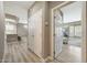 Hallway view into kitchen and bedroom with white doors at 16427 W Labyrinth Ln, Surprise, AZ 85374