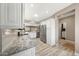 Bright kitchen features granite counters, stainless steel appliances, and wood-look flooring at 16427 W Labyrinth Ln, Surprise, AZ 85374