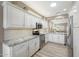 Modern kitchen featuring white cabinets, stainless steel appliances, and granite countertops at 16427 W Labyrinth Ln, Surprise, AZ 85374