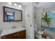 Practical bathroom featuring a vanity with sink and a toilet adjacent to a shower with a palm tree curtain at 1645 W Baseline Rd # 2125, Mesa, AZ 85202