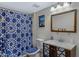 Cozy bathroom with a vanity, toilet, and a shower with a decorative blue patterned curtain at 1645 W Baseline Rd # 2125, Mesa, AZ 85202