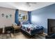 Blue accent wall bedroom with a bed, side table, and a mounted TV, offering a cozy retreat at 1645 W Baseline Rd # 2125, Mesa, AZ 85202