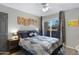Well-lit bedroom with modern decor, gray walls, and a sliding glass door with dark curtains at 1645 W Baseline Rd # 2125, Mesa, AZ 85202