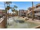 A beautiful water feature with fountain and palm trees enhances the community's curb appeal and serene atmosphere at 1645 W Baseline Rd # 2125, Mesa, AZ 85202