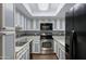 Galley kitchen featuring stainless steel appliances and white cabinets at 1645 W Baseline Rd # 2125, Mesa, AZ 85202