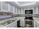 Kitchen featuring white cabinets, stainless steel appliances and ample counter space at 1645 W Baseline Rd # 2125, Mesa, AZ 85202