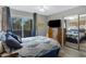 A comfortable main bedroom with a sliding glass door, dresser, and mirrored closet at 1645 W Baseline Rd # 2125, Mesa, AZ 85202