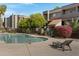 Inviting community pool area with lounge chairs, a clear blue pool, and well-maintained landscaping at 1645 W Baseline Rd # 2125, Mesa, AZ 85202