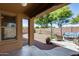 Inviting covered back patio with a pergola, seating, and gravel landscaping at 16820 N 152Nd Ln, Surprise, AZ 85374