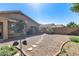 Low-maintenance backyard with stepping stones, rock landscaping, and a metal flower decoration at 16820 N 152Nd Ln, Surprise, AZ 85374