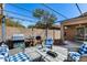 Outdoor patio featuring comfortable seating, a grill, and overhead shade covering at 16820 N 152Nd Ln, Surprise, AZ 85374
