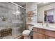 Modern bathroom with a glass-enclosed shower, wooden vanity, and a neutral color palette at 16820 N 152Nd Ln, Surprise, AZ 85374