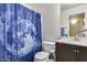 Clean bathroom with modern fixtures, a blue shower curtain, and bright lighting at 16820 N 152Nd Ln, Surprise, AZ 85374