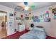 Bright bedroom featuring colorful ceiling fan, red carpet, and natural light at 16820 N 152Nd Ln, Surprise, AZ 85374