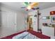 A bright bedroom featuring double closets, a ceiling fan, and a dresser at 16820 N 152Nd Ln, Surprise, AZ 85374
