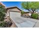 Beautiful home featuring a two-car garage, neutral colors, and desert landscaping with a green tree at 16820 N 152Nd Ln, Surprise, AZ 85374