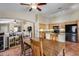 Modern kitchen featuring tile flooring, an island sink, granite counters, wood cabinets, and black appliances at 16820 N 152Nd Ln, Surprise, AZ 85374