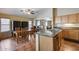 Spacious kitchen with granite counters, stainless steel sink, wood cabinets, and open dining area at 16820 N 152Nd Ln, Surprise, AZ 85374