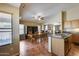 Kitchen with granite counters, wooden cabinets, stainless steel sink, and a dining area at 16820 N 152Nd Ln, Surprise, AZ 85374