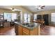 Open kitchen with an island, stainless steel appliances, granite countertops, and eat-in dining area at 16820 N 152Nd Ln, Surprise, AZ 85374