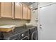 Well-equipped laundry room featuring modern machines, ample storage, and utility sink at 16820 N 152Nd Ln, Surprise, AZ 85374