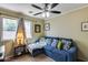 Inviting living room featuring a comfortable blue couch, throw pillows, and natural light at 16820 N 152Nd Ln, Surprise, AZ 85374