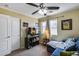 Comfortable living room featuring a TV, blue couch, natural light, and ceiling fan at 16820 N 152Nd Ln, Surprise, AZ 85374