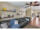Comfortable living room with a large gray sofa, soft rug, and built-in bookshelves at 16820 N 152Nd Ln, Surprise, AZ 85374