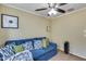 Relaxing living room featuring a blue couch, neutral walls, and natural light at 16820 N 152Nd Ln, Surprise, AZ 85374