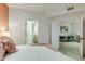 Bright bedroom featuring a king bed, with a view to the bathroom and an office space at 1701 E Colter St # 488, Phoenix, AZ 85016