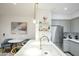 Bright kitchen featuring stainless appliances, marble counters, a waterfall island, and a dining nook at 1701 E Colter St # 488, Phoenix, AZ 85016