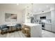 Open kitchen boasts stainless appliances, a waterfall island with seating, and a dining area at 1701 E Colter St # 488, Phoenix, AZ 85016